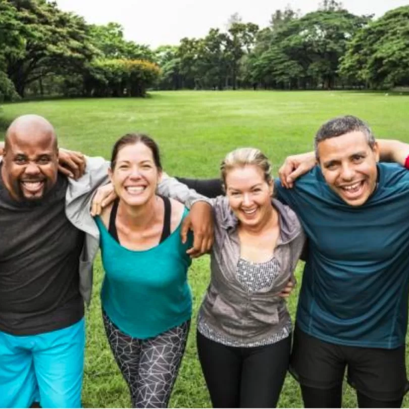 Group of people holding each other in a field