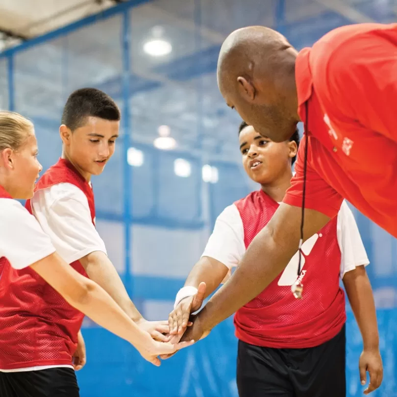 Basketball coach with team huddling