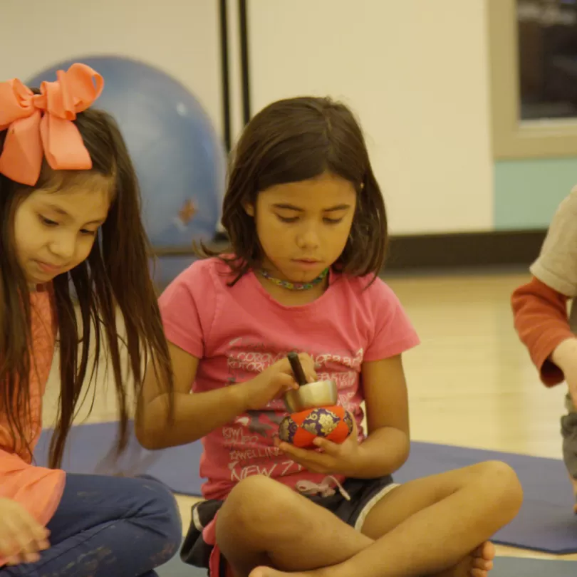 Three children sitting on the floor 