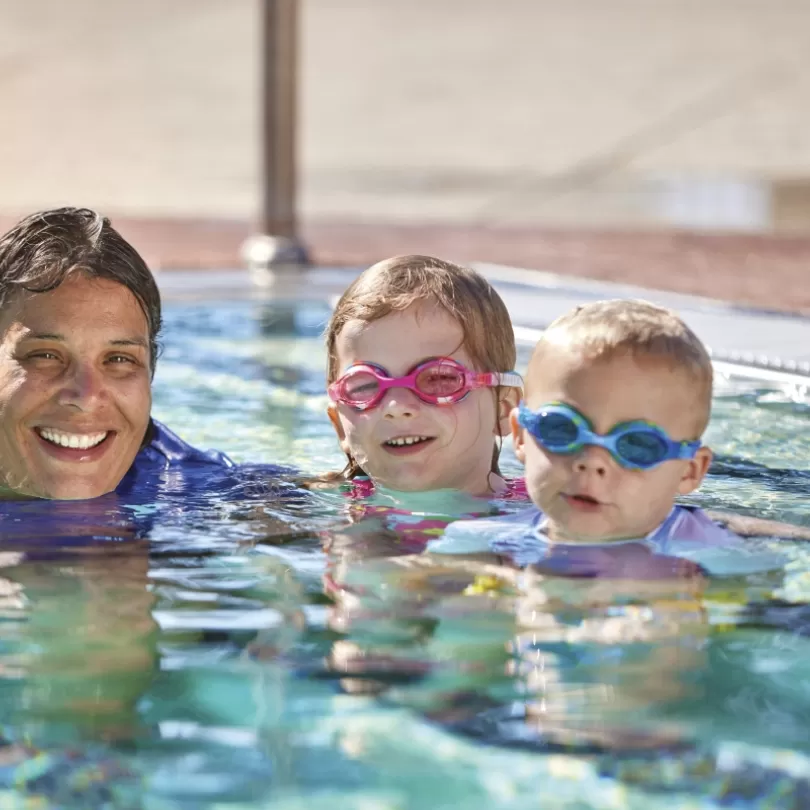 Adult and children in pool