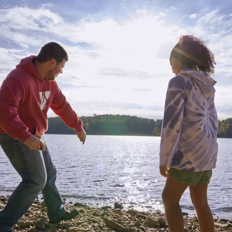 YMCA staff and kids skipping rocks