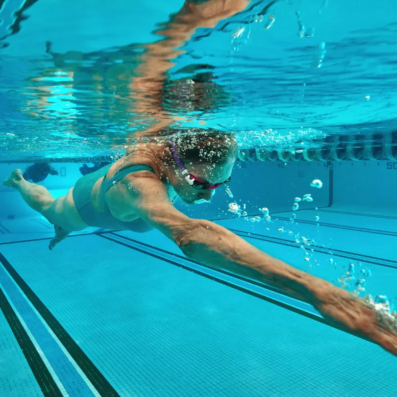A woman swimming laps underwater.