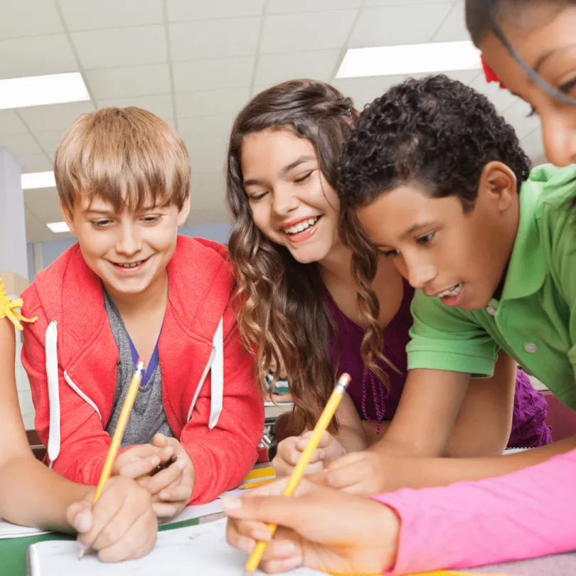 Middle school kids work on a project at school.
