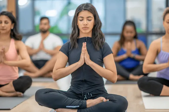 Woman in group yoga class.