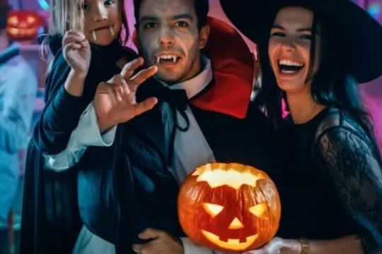 A family dresses up in Halloween costumes for a Monster Mash Dance party.