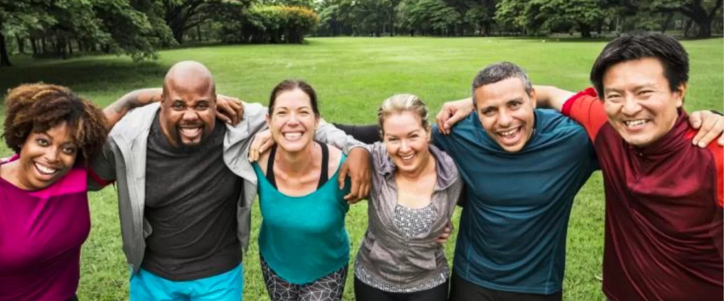 Group of people holding each other in a field