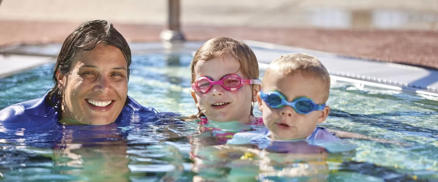 Adult and children in pool