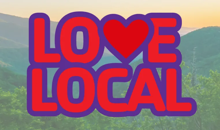 The Love Local logo with mountains in the background.