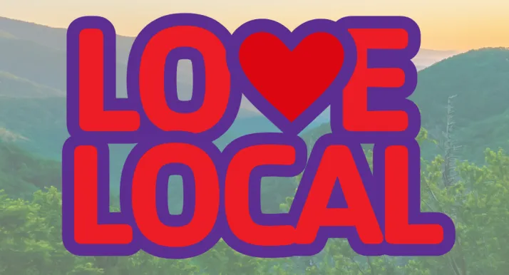 The Love Local logo with mountains in the background.