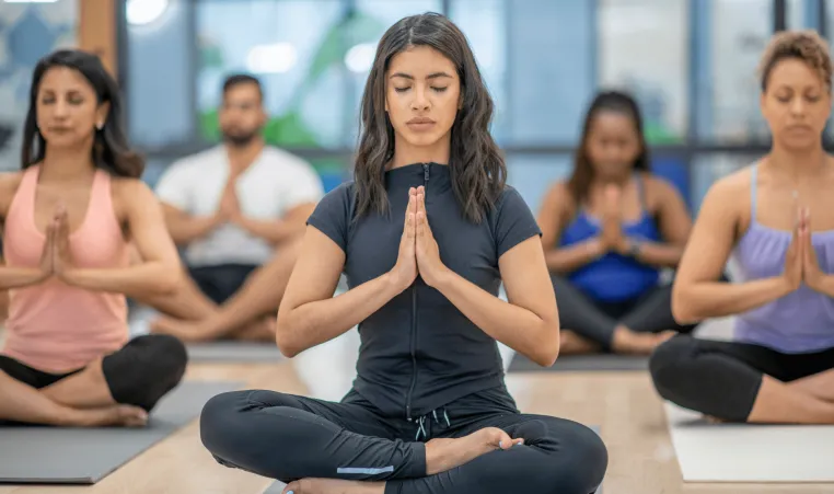 Woman in group yoga class.