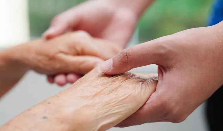 elderly holding hands