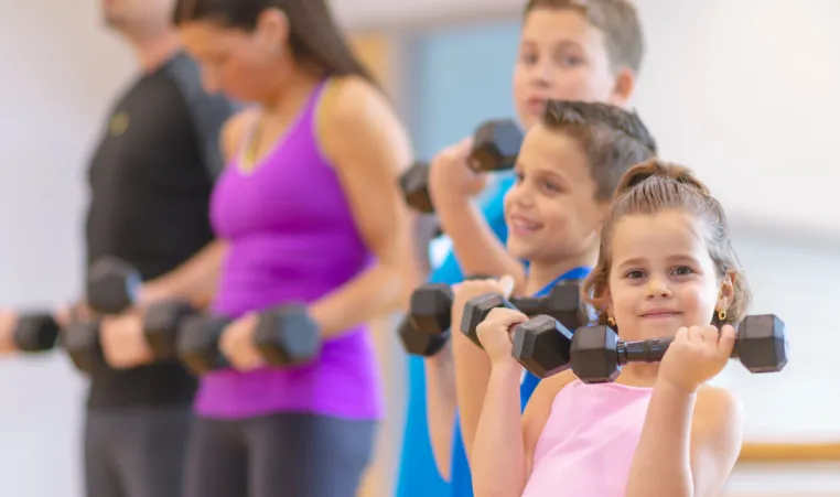 A family exercises together at the gym.